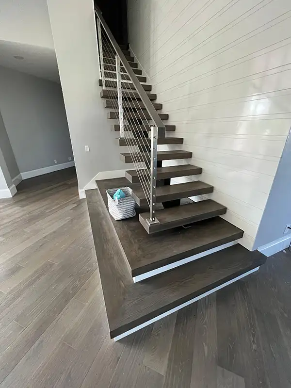 Floating staircase with wood treads and metal railing